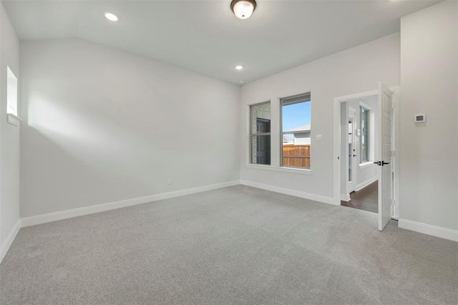 Carpeted spare room featuring baseboards and recessed lighting