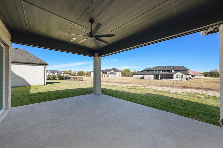 View of patio / terrace featuring ceiling fan and a residential view