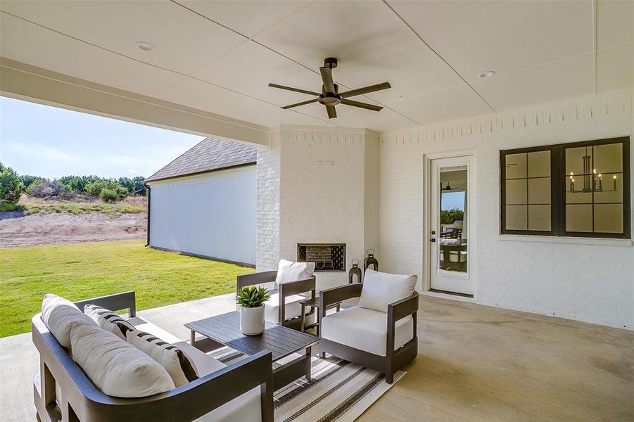 View of patio with an outdoor hangout area and ceiling fan