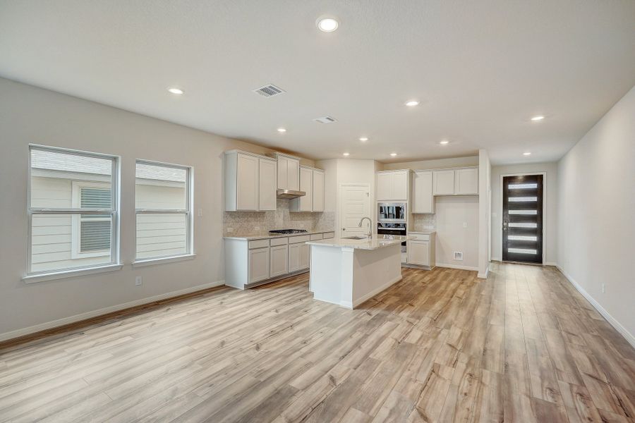 Dining room and kitchen in the Pearl floorplan at a Meritage Homes community.