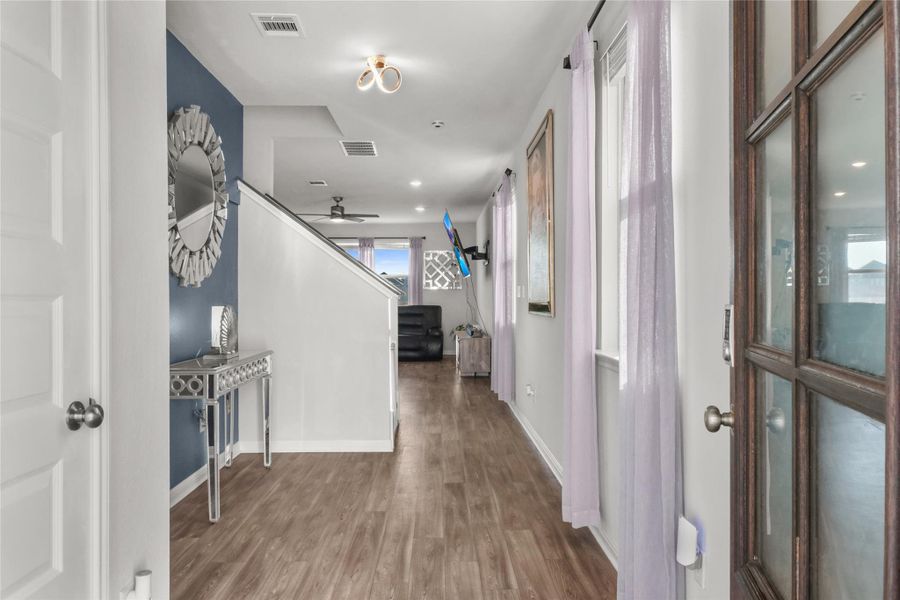 Hall featuring wood finished floors and baseboards