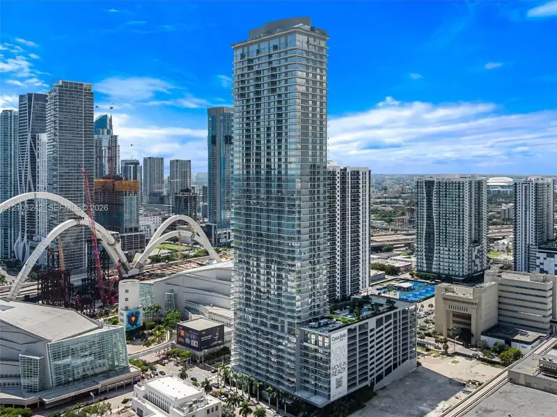High-rise architectural tower featuring floor-to-ceiling glass paneling, a multi-level structure, private balconies, and an elevated outdoor deck High-rise architectural tower featuring floor-to-ceiling glass paneling, a multi-level structure, private balconies, and an elevated outdoor deck