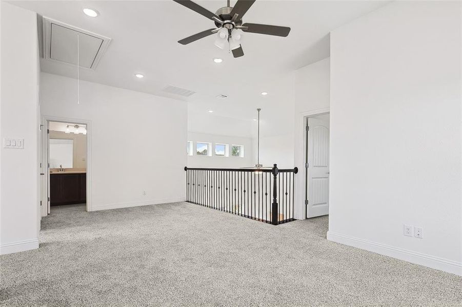 Carpeted empty room with ceiling fan