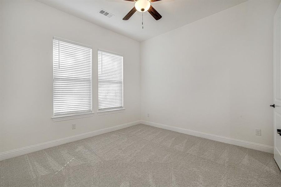 Spare room with ceiling fan and carpet floors