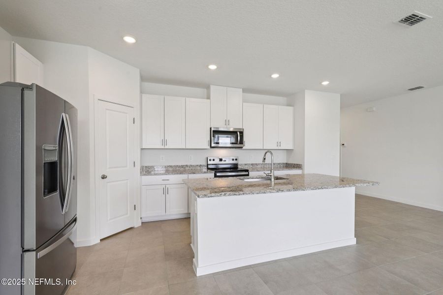 Furnished interior view inside a new home in Lakes at Bella Lago - Signature Series, Green Cove Springs (Image 6). Furnished interior view inside a new home in Lakes at Bella Lago - Signature Series, Green Cove Springs (Image 6).