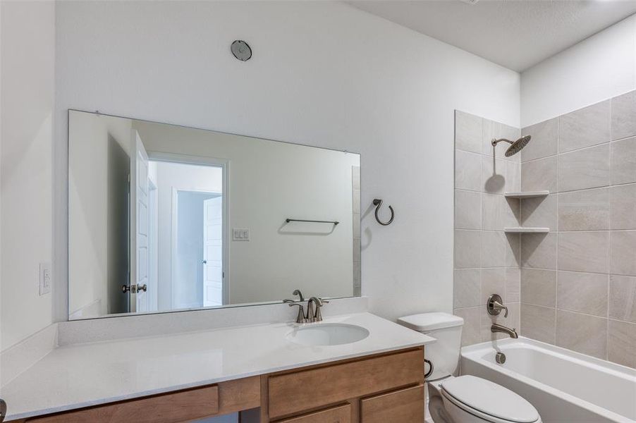 Full bathroom with washtub / shower combination and vanity