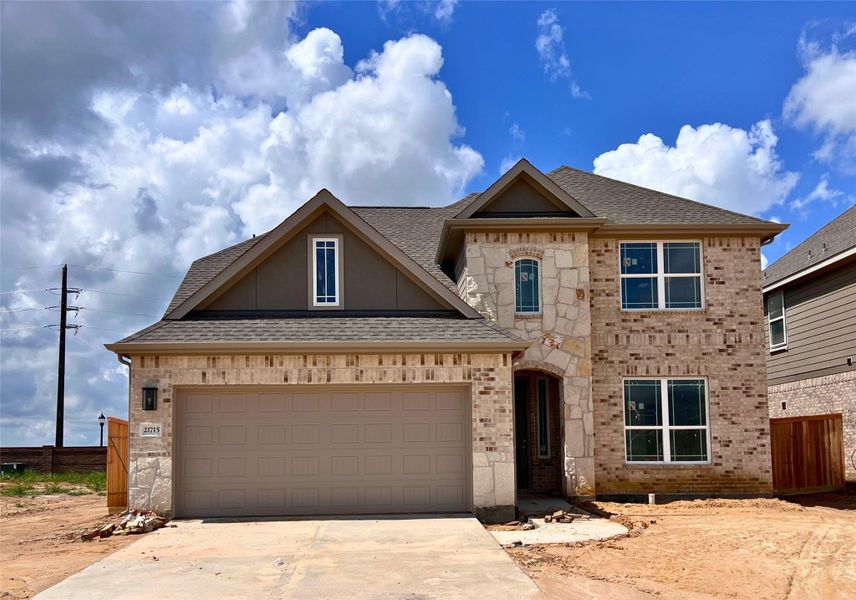 Front exterior of a new home in Cypress Green, Hockley, TX, highlighting curb appeal (Image 1). Front exterior of a new home in Cypress Green, Hockley, TX, highlighting curb appeal (Image 1).