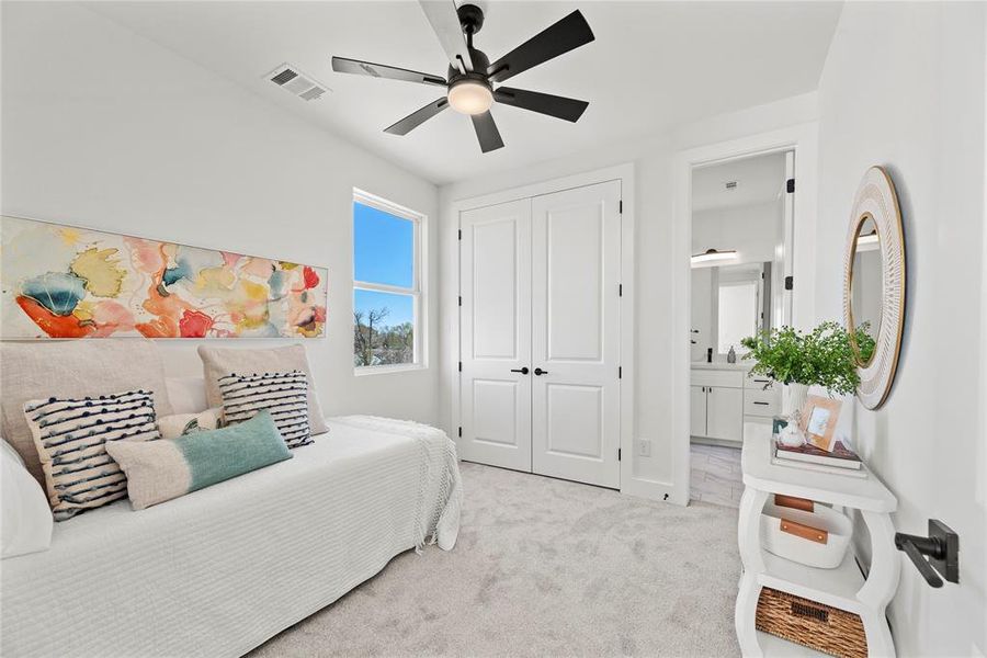 The secondary bedroom is light and bright with a large closet and en-suite bath.