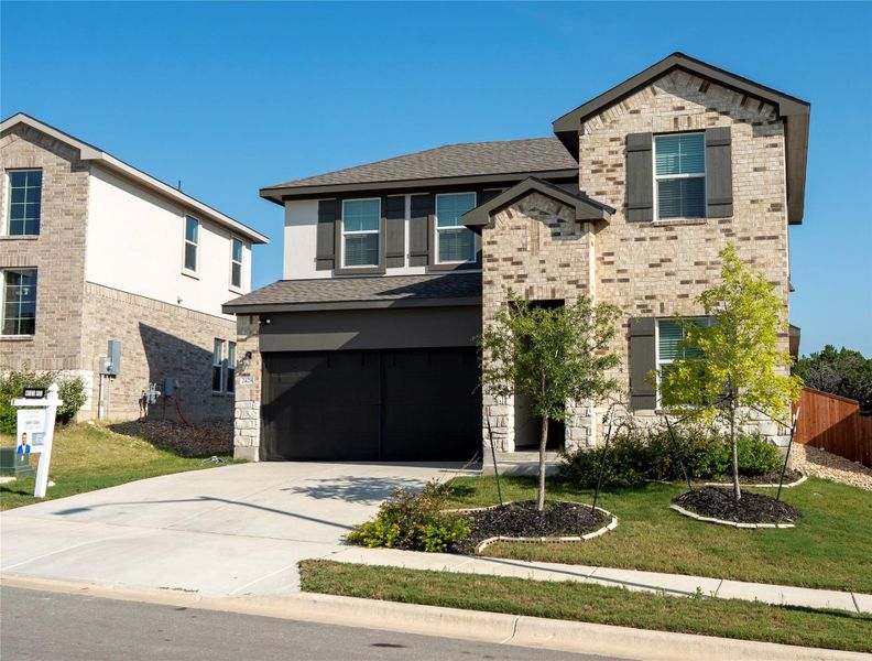 Front exterior of a new home in Bar W Ranch, Leander, TX, highlighting curb appeal (Image 2).