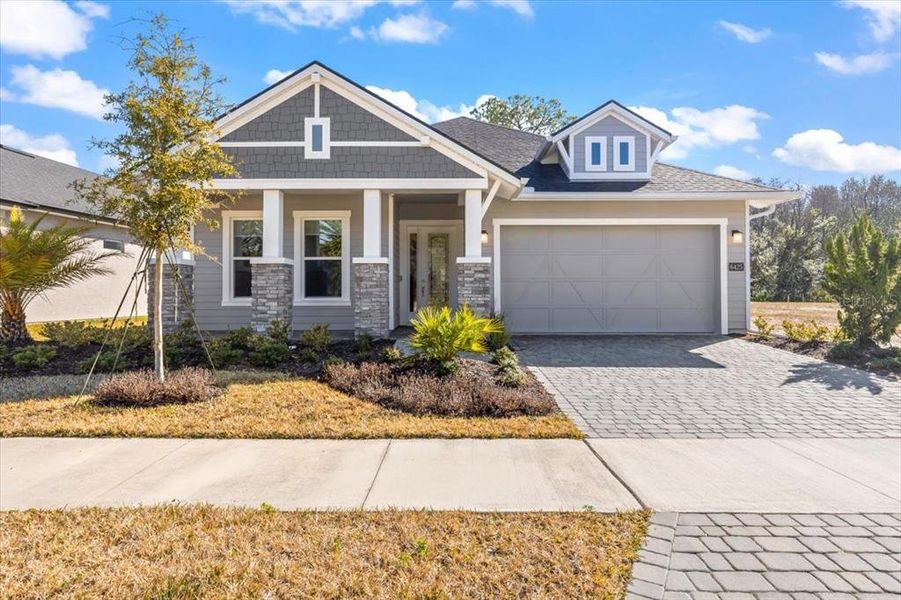 Front exterior of a new home in Woodhaven, Port Orange, FL, highlighting curb appeal (Image 27). Front exterior of a new home in Woodhaven, Port Orange, FL, highlighting curb appeal (Image 27).