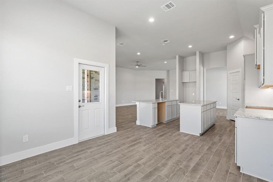 Enjoy breakfast with ease in the connected and cozy breakfast area, seamlessly integrated with the kitchen for utmost convenience. Sample photo of completed home with similar floor plan. As-built interior colors and selections may vary.