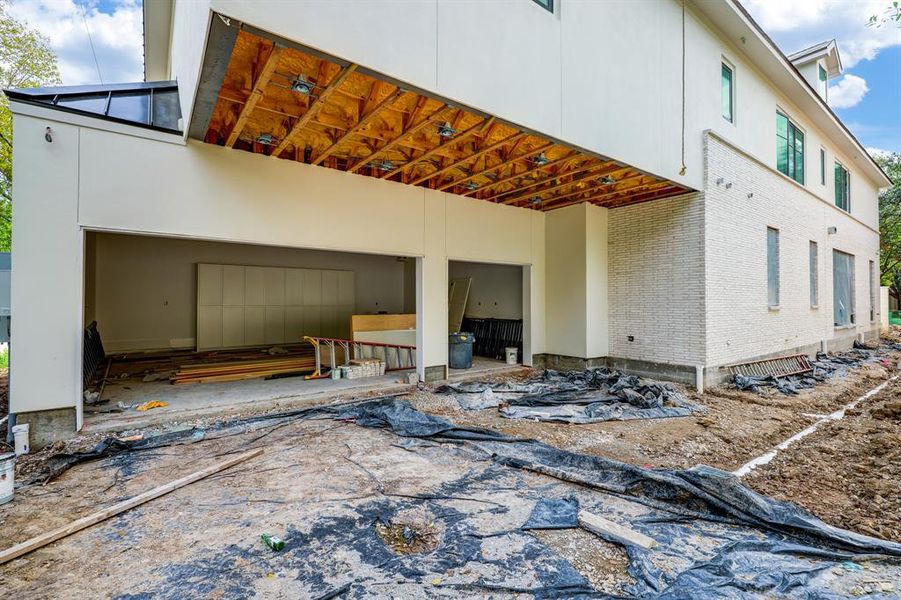 Three-car garage. Drive now poured.