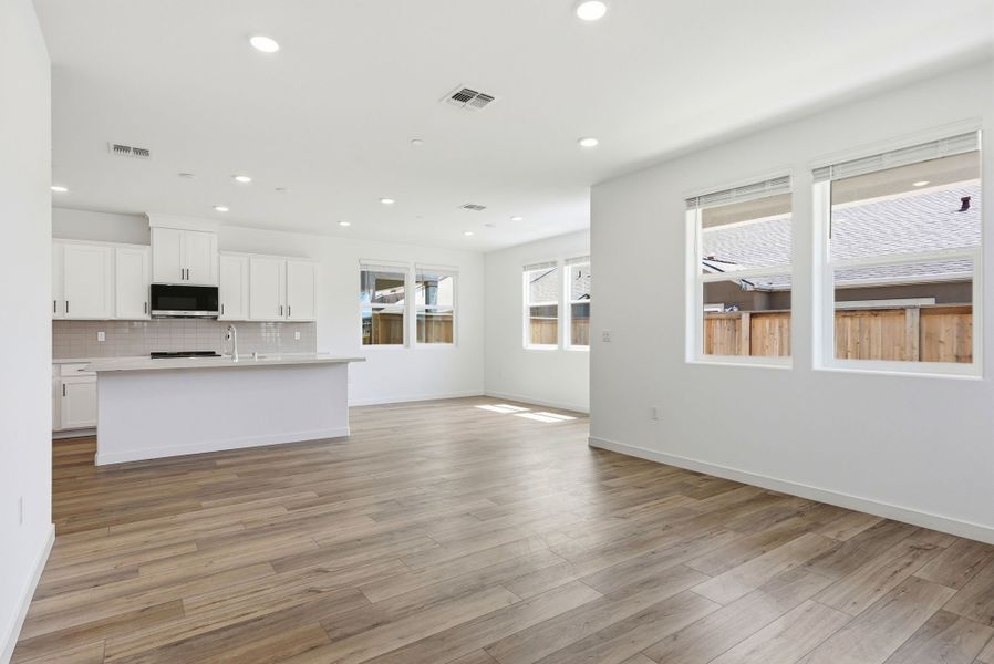 A large kitchen with white cabinets. A large kitchen with white cabinets.