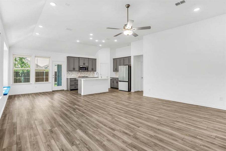 Open-concept living space with wood-finish flooring