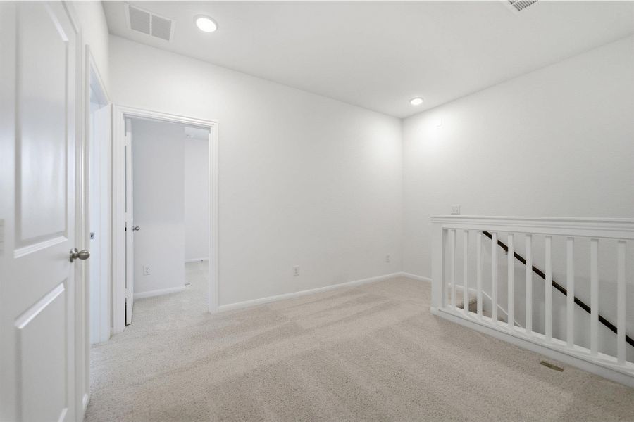 Spare room featuring light carpet and recessed lighting Spare room featuring light carpet and recessed lighting