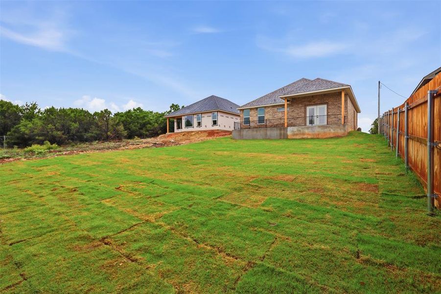 Expansive green lawn with newly laid sod provides a sizable exterior space Expansive green lawn with newly laid sod provides a sizable exterior space