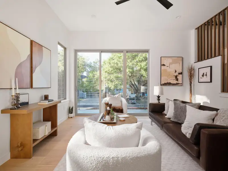 Living area featuring plenty of natural light, light wood finished floors, and a ceiling fan