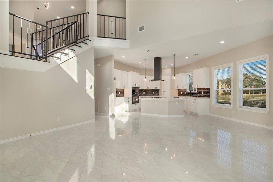 Unfurnished living room with a high ceiling