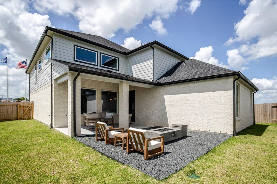 The rear of the home featurs a spacious backyard patio area enclosed by a wooden fence, offering privacy. The rear of the home featurs a spacious backyard patio area enclosed by a wooden fence, offering privacy.