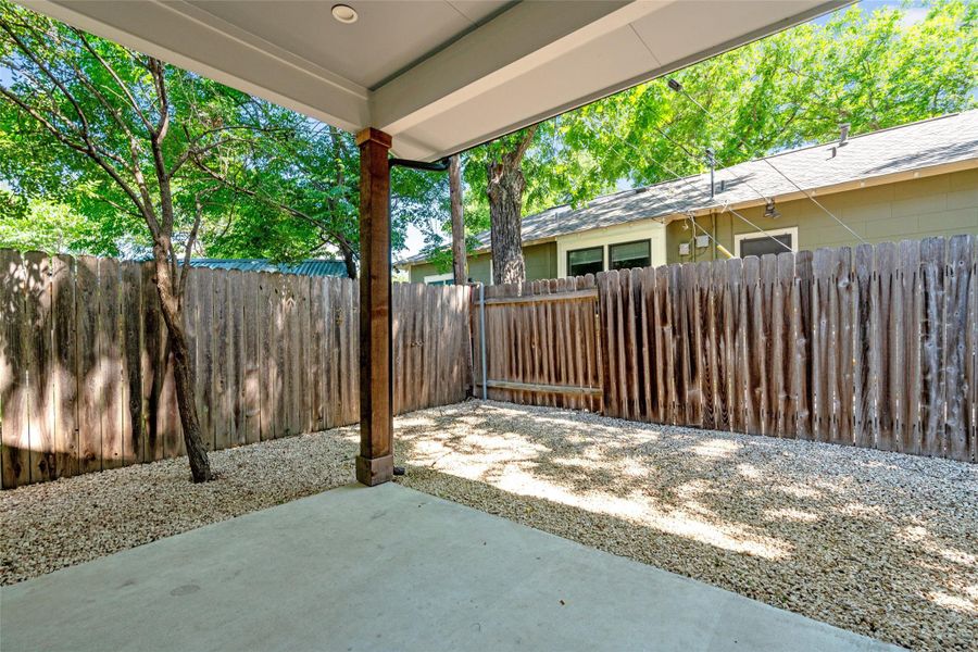 Outdoor patio space featuring a concrete slab, zero landscaping and fully fenced for privacy. Outdoor patio space featuring a concrete slab, zero landscaping and fully fenced for privacy.