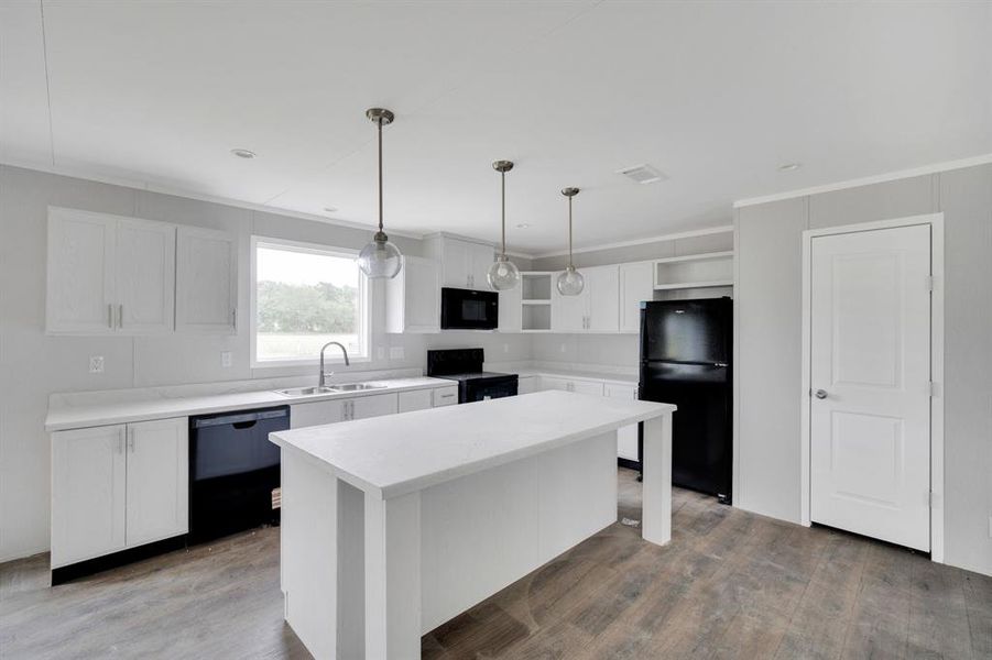 Open-concept kitchen with white cabinetry and an island
