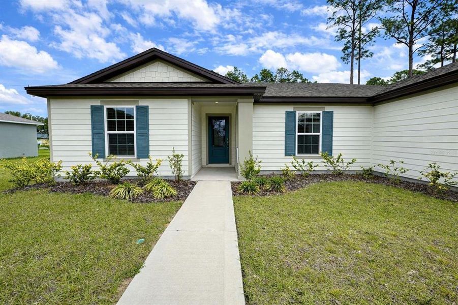 Front exterior of a new home in Palm Coast, Palm Coast, FL, highlighting curb appeal (Image 2). Front exterior of a new home in Palm Coast, Palm Coast, FL, highlighting curb appeal (Image 2).