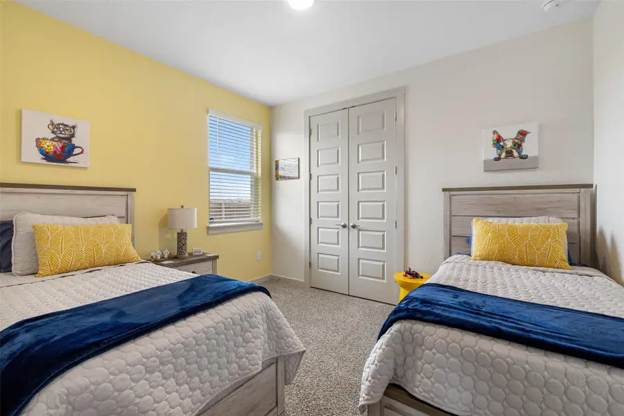 Carpeted bedroom featuring a closet and baseboards Carpeted bedroom featuring a closet and baseboards