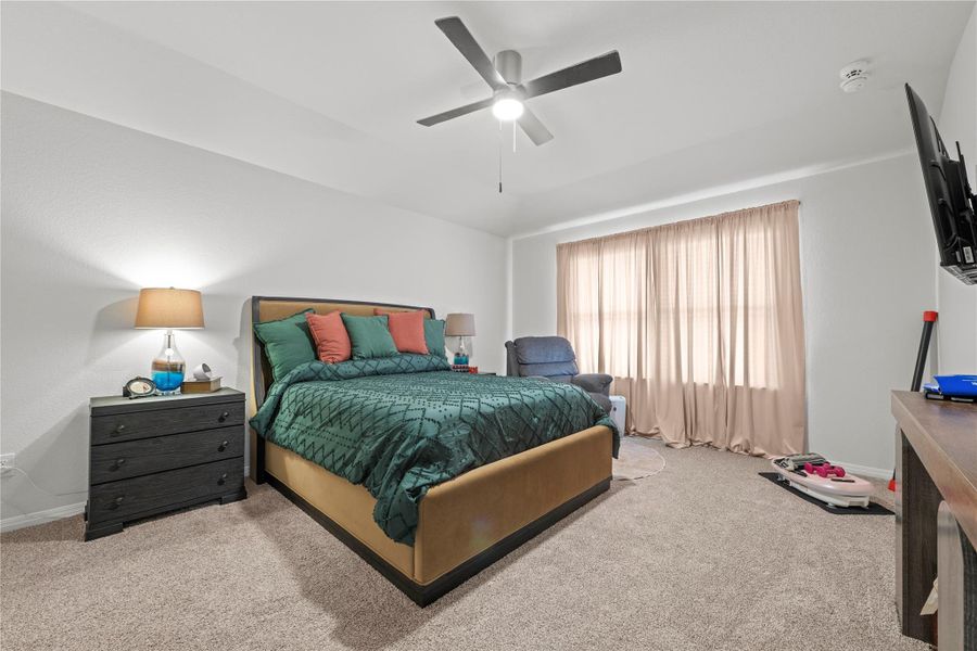 Well-lit sleeping quarters offer a spacious layout and comfortable carpeted flooring.