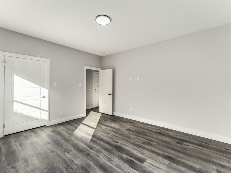 Empty room featuring dark hardwood / wood-style flooring