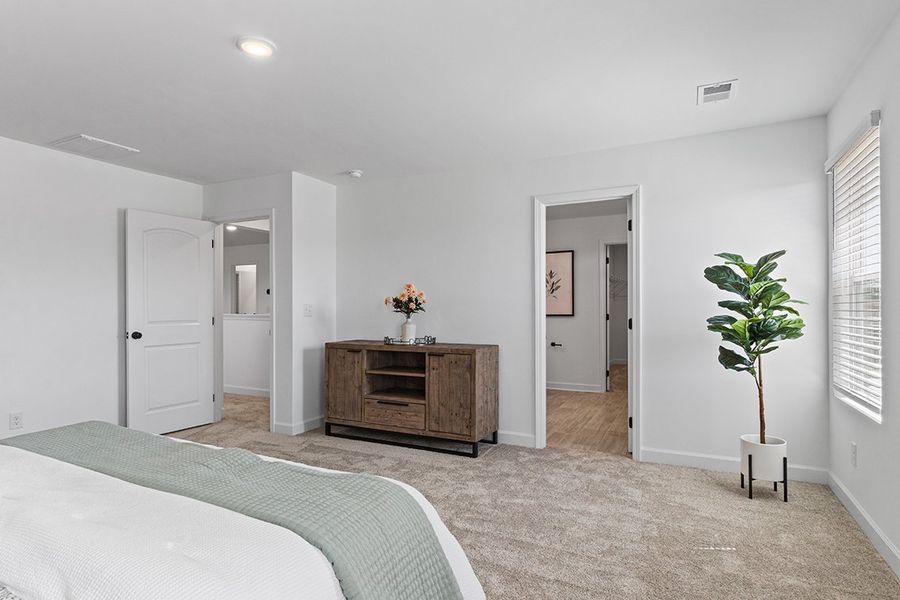 A bedroom with a bed and a dresser.