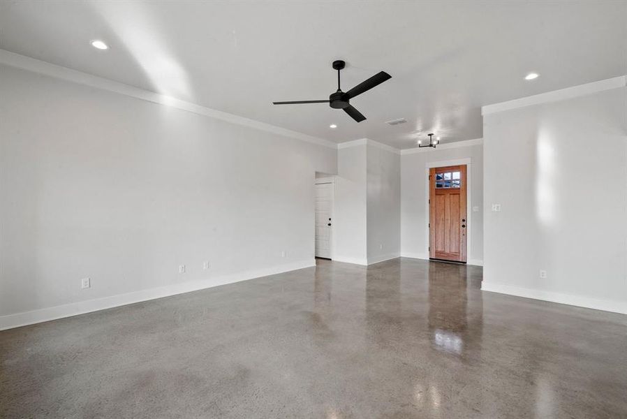 Unfurnished room featuring ceiling fan and ornamental molding