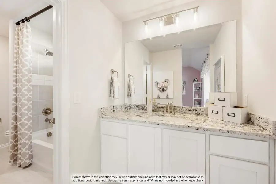 Bathroom with white cabinets, granite countertop, large mirror, and separate tub-shower with curtain