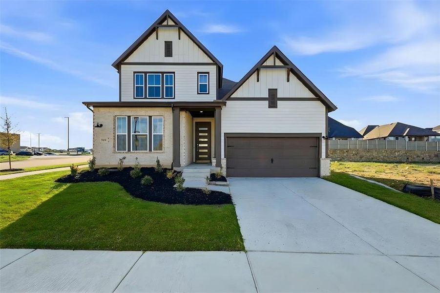 View of front facade featuring board and batten siding, a front lawn, and concrete driveway View of front facade featuring board and batten siding, a front lawn, and concrete driveway