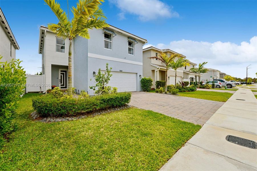 Front exterior of a new home in Messina Place, Homestead, FL, highlighting curb appeal (Image 25).