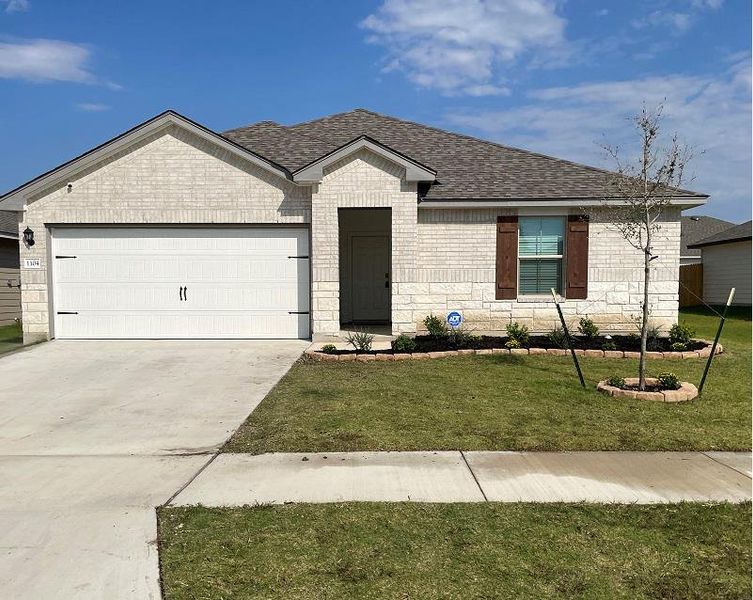 Ranch-style home featuring an attached garage, brick siding, concrete driveway, a shingled roof, and stone siding