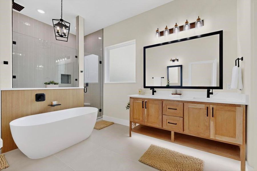 Full bath with a stall shower, double vanity, a soaking tub, light tile patterned floors, and recessed lighting Full bath with a stall shower, double vanity, a soaking tub, light tile patterned floors, and recessed lighting