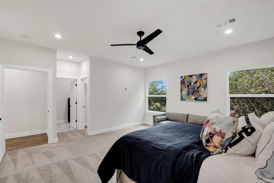 Carpeted Primary Bedroom with ceiling fan