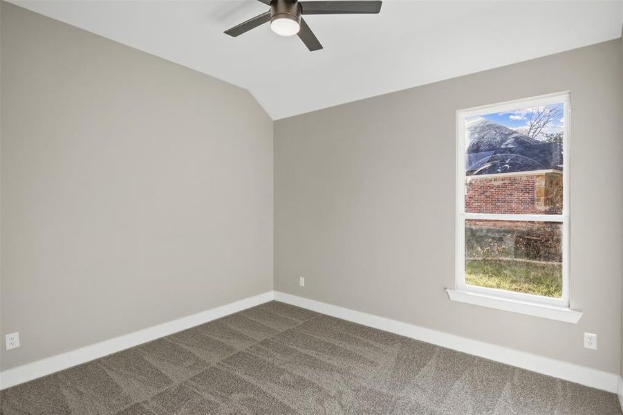 Unfurnished room with carpet flooring, lofted ceiling, and ceiling fan