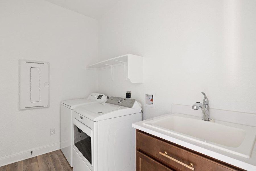 Laundry area with light wood finished floors, cabinet space, and washing machine and dryer Laundry area with light wood finished floors, cabinet space, and washing machine and dryer