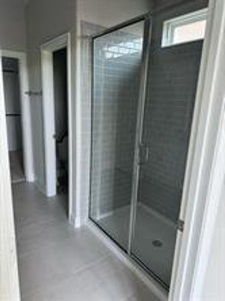 Bathroom with tile patterned flooring and walk in shower