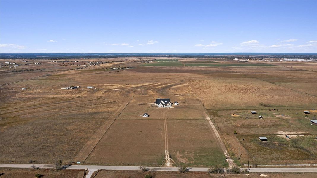 Sprawling acreage surrounds a contemporary farmhouse, offering pastoral tranquility. Sprawling acreage surrounds a contemporary farmhouse, offering pastoral tranquility.