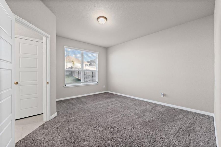 Spare room featuring light colored carpet and baseboards Spare room featuring light colored carpet and baseboards