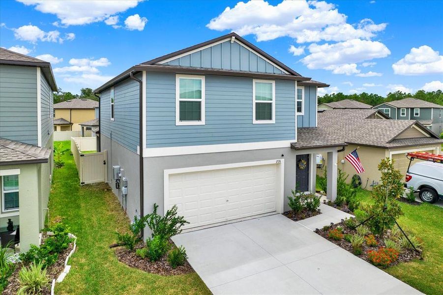 Front exterior of a new home in Two Rivers: The Manors II, Zephyrhills, FL, highlighting curb appeal (Image 21). Front exterior of a new home in Two Rivers: The Manors II, Zephyrhills, FL, highlighting curb appeal (Image 21).