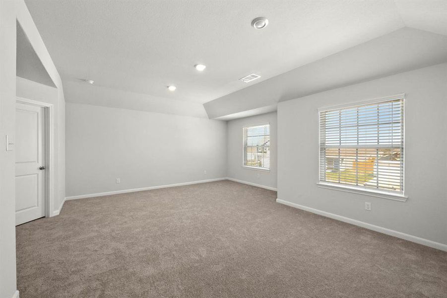 The expansive, primary bedroom is the perfect place to relax after a long day.