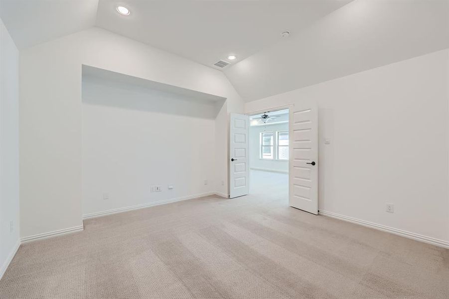 Media room with ceiling fan and lofted ceiling