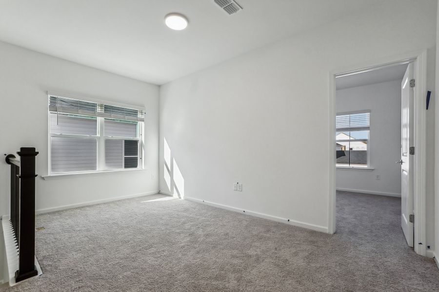 Representative unfurnished interior of a home built from the Macon by Ashton Woods in Rowland's Grant, Fuquay Varina (Image 38).