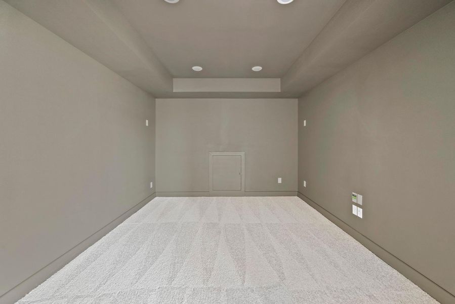 Spare room with a raised ceiling, baseboards, carpet, and recessed lighting