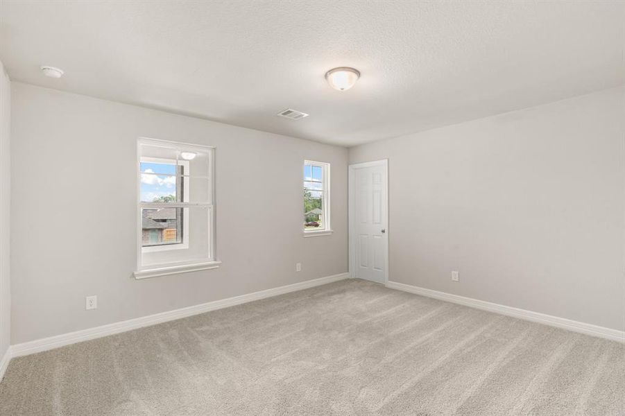 Your secondary bedroom features plush carpet, fresh paint, closet, and a large window that lets in plenty of natural lighting.