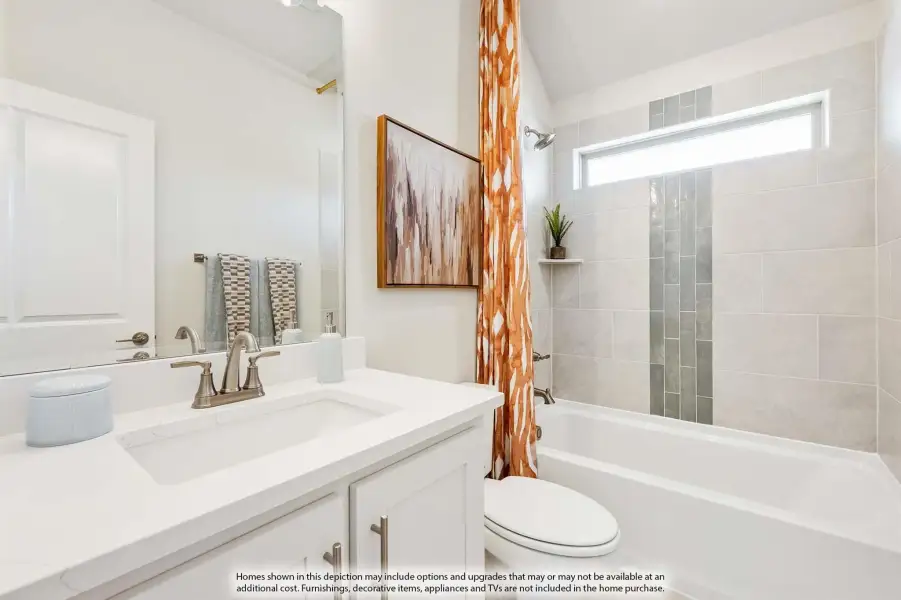 Bathroom with white vanity, tiled shower-tub combo, and vaulted ceiling