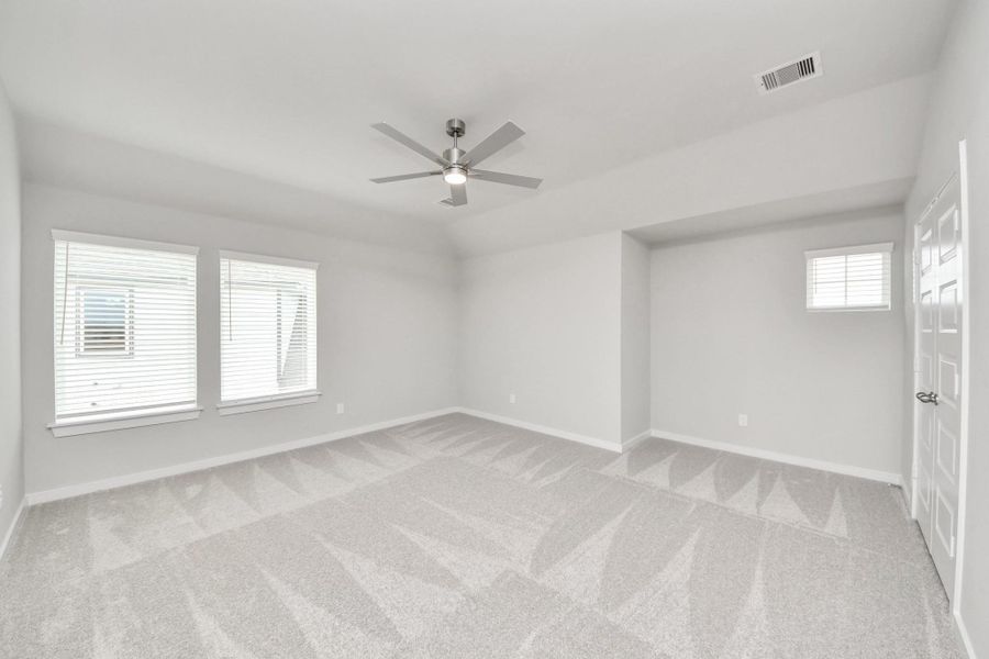 Ascend to relaxation in this fantastic game room! Ideal for both casual gatherings and adult gaming, it boasts plush carpet, lofty ceilings, custom paint, and ample windows for abundant natural light